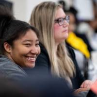 Girls of Color Summit previous event where a girl laughs at something that was said